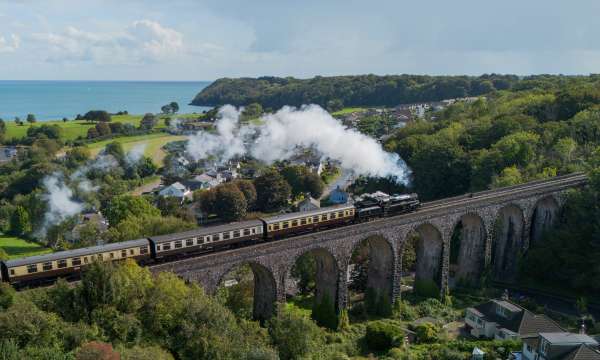 Steam train going over bridge