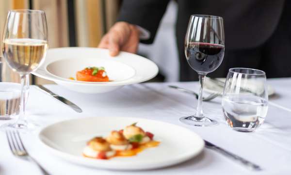 Someone putting down a plate of food at the Arlington Restaurant