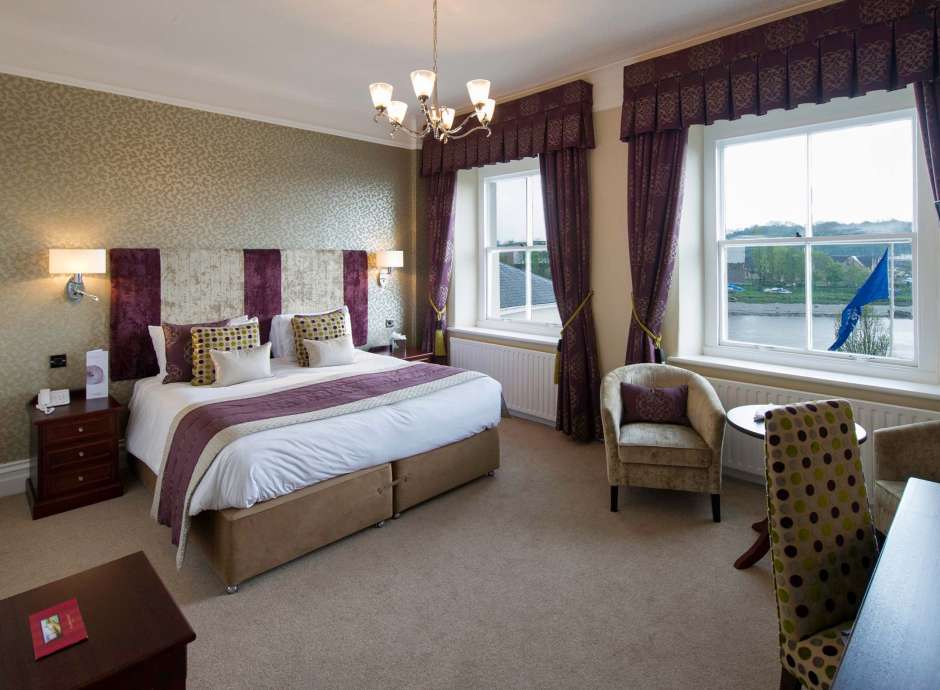 Imperial Hotel Accommodation Bedroom with Seating Area and View of River