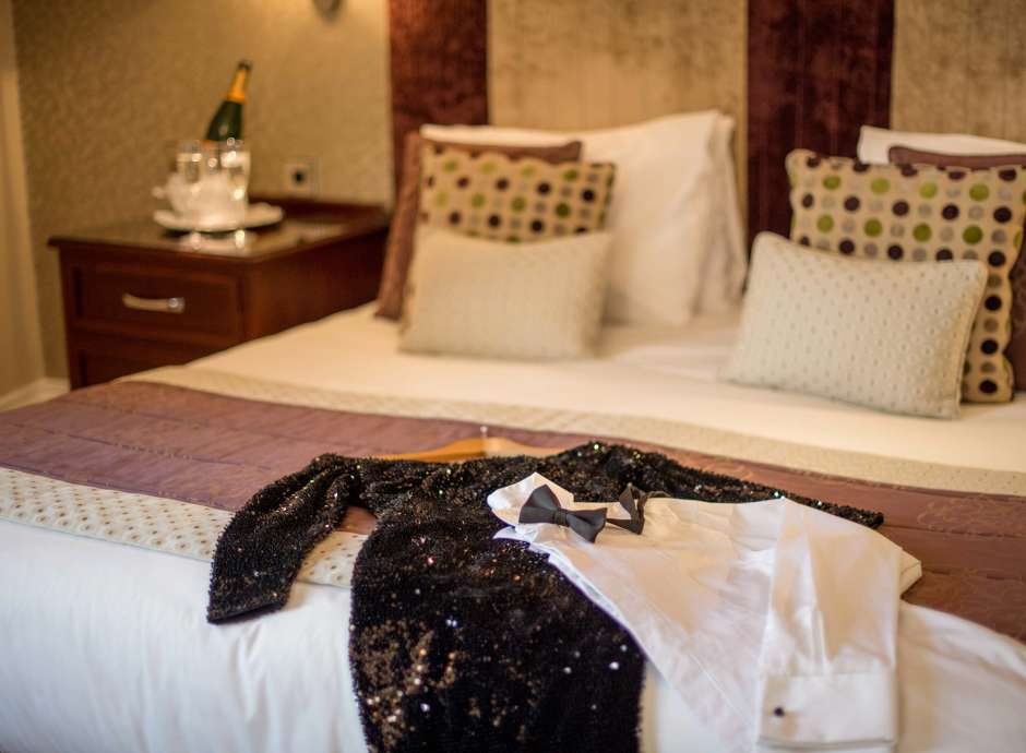 Imperial Hotel Christmas Party Clothes on Bed with Champagne Flutes