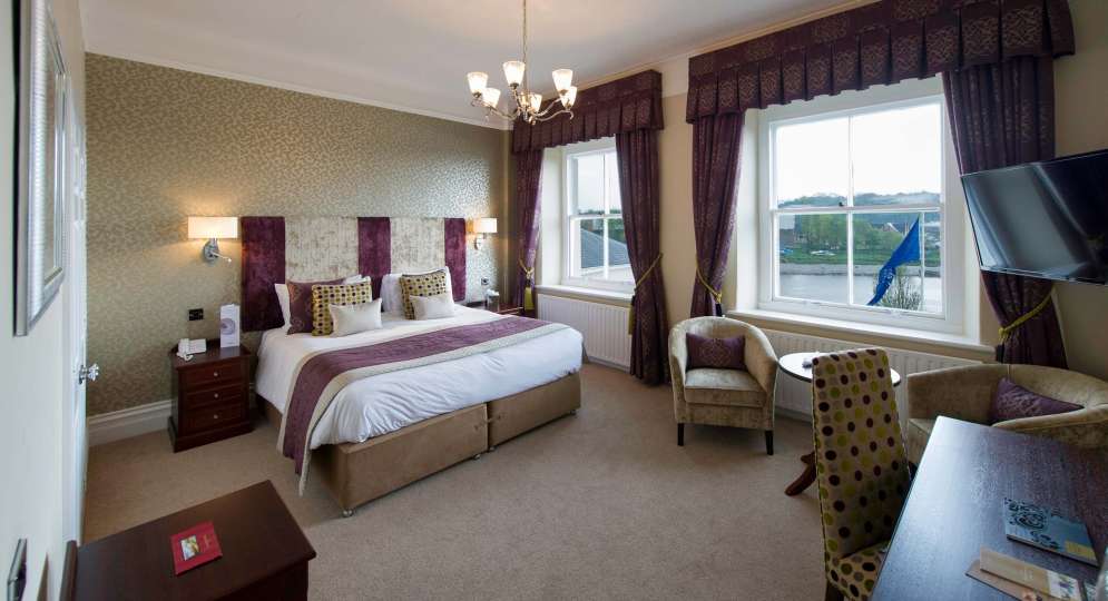Imperial Hotel Accommodation Bedroom with Seating Area and View of River